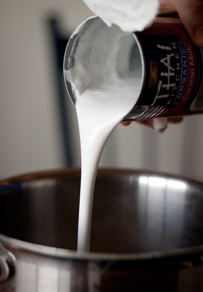 coconut milk being poured from can
