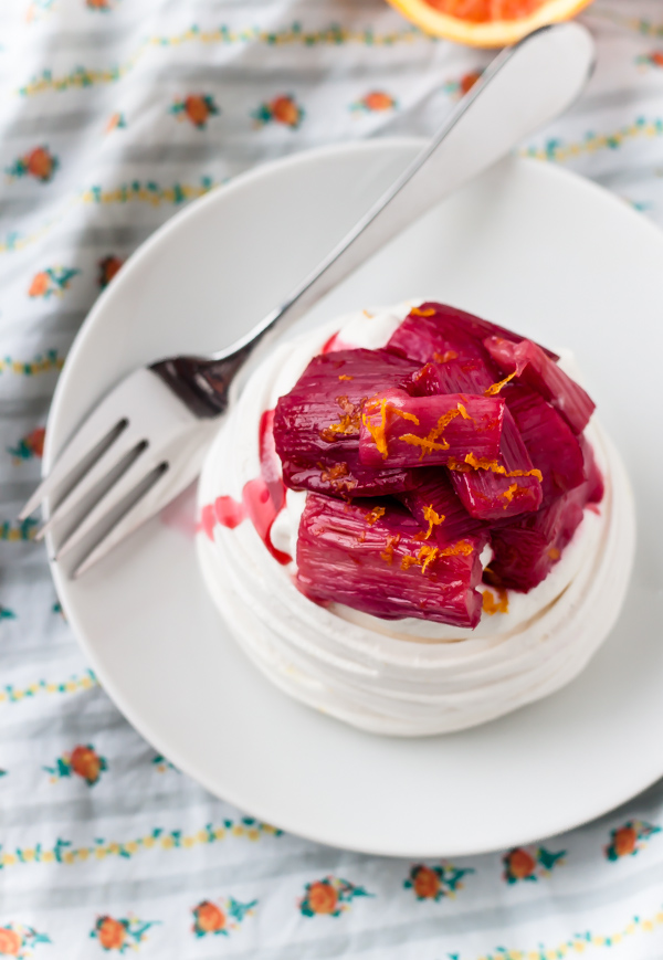 Homemade meringue cups are filled with vanilla bean whipped cream and roasted rhubarb. The perfect spring dessert!