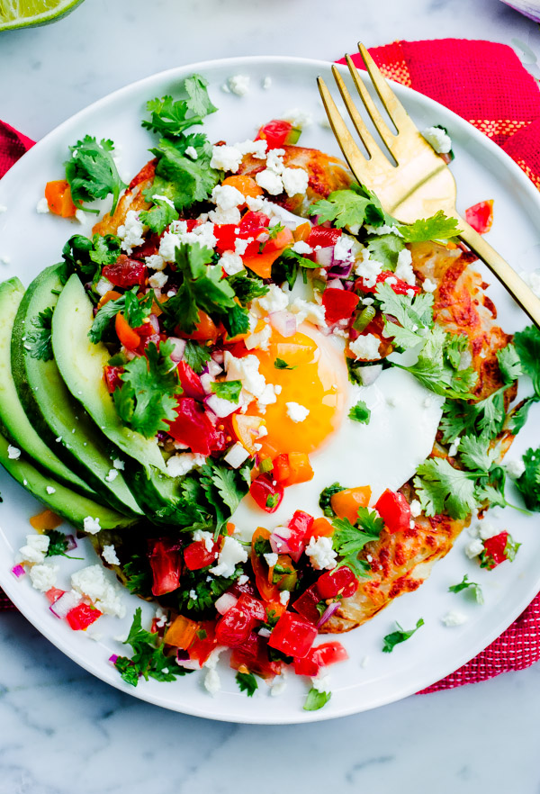 Mexican Hash Brown Stack. Crispy potato topped with sunny-side eggs, sliced avocado, homemade pico de gallo, and crumbled queso fresco cheese! 