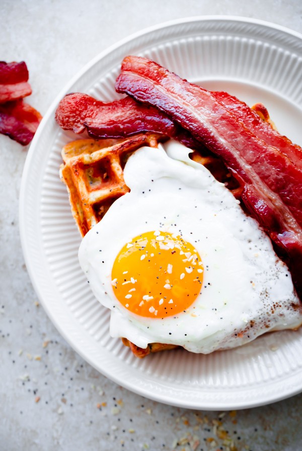 Everything Bagel Breakfast Waffles. Topped with sunny-side eggs and crispy bacon!