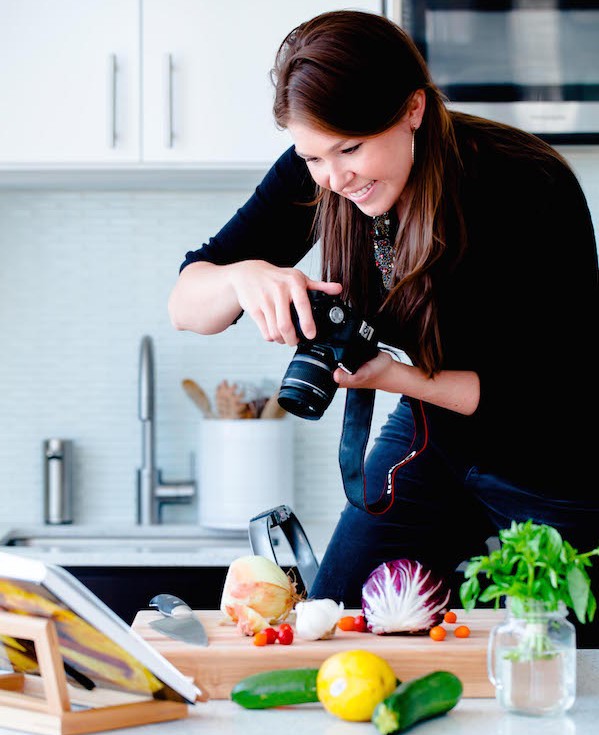 Woman Photographing A Recipe In a Kitchen