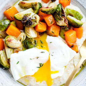 Creamy Goat Cheese Grits with Roasted Brussels Sprouts and Squash and Poached Eggs. A delicious, EASY vegetarian dinner recipe!