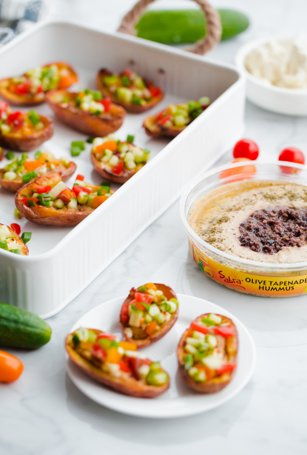 Greek-Style Potato Skins with Hummus. A HEALTHY and easy potato skin recipe made with hummus, feta, and chopped vegetables - a great party or tailgating appetizer!