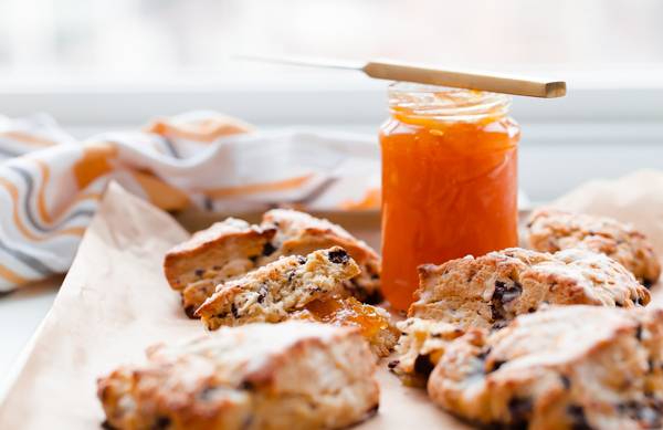 Orange chocolate chunk scones topped with a fresh orange glaze - this flaky cream scone recipe can be prepared in just over 30 minutes, or baked ahead of time!