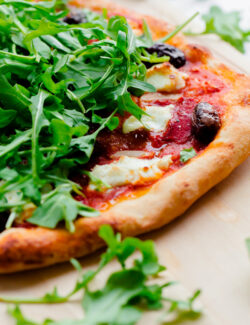 Spicy Red Pepper, Goat Cheese, Olive, and Arugula Pizza