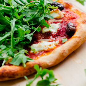 Spicy Red Pepper, Goat Cheese, Olive, and Arugula Pizza