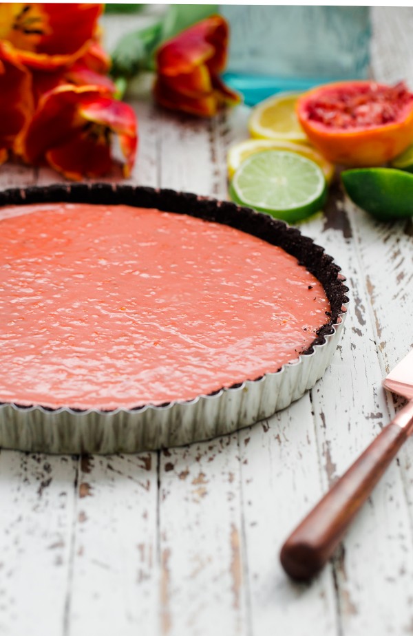 Triple citrus tart with chocolate crust and berries