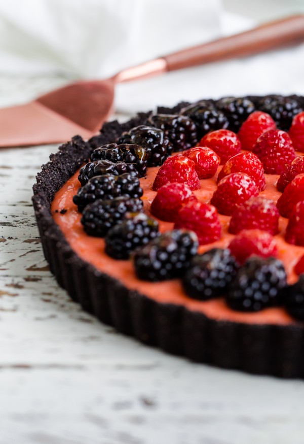 Triple citrus tart with chocolate crust and berries