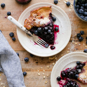 Gluten Free Dutch Baby with Blueberry Maple Syrup. This easy Dutch baby recipe is 100% whole grain and made with gluten free rolled oats!