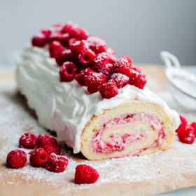 Raspberry Roll Cake. Vanilla sponge cake filled with fresh raspberries and whipped cream!