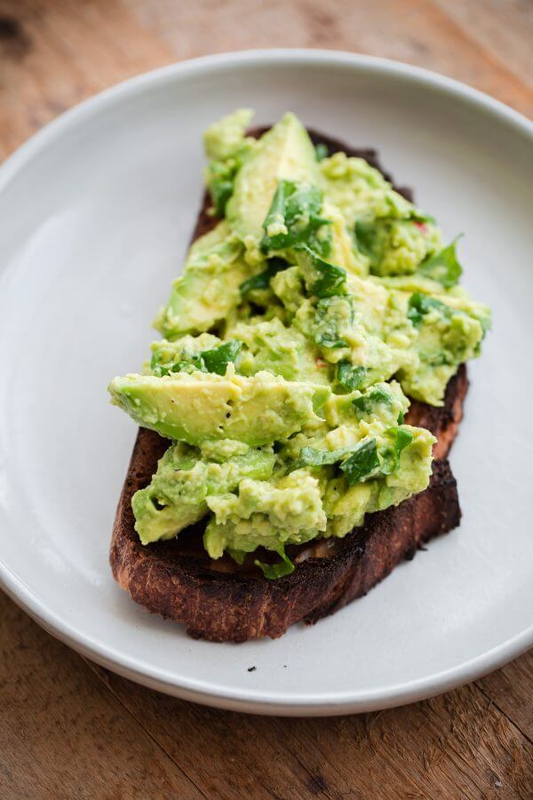 Fancy Avocado Toast - chunky avocado with lemon, chili flakes, basil - topped with a soft boiled egg!