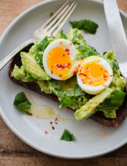 Fancy Avocado Toast - chunky avocado with lemon, chili flakes, basil - topped with a soft boiled egg!