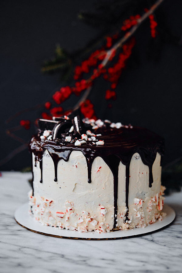 Candy Cane Crunch Cake. Peppermint chocolate layer cake filled with candy cane Swiss meringue buttercream and topped with peppermint ganache. Perfect celebration cake for the holidays!
