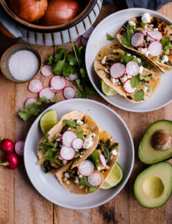 Salsa Verde Chicken Tacos. These easy chicken tacos are made with braised chicken thighs, poblano peppers, onions, and roasted tomatillo salsa!