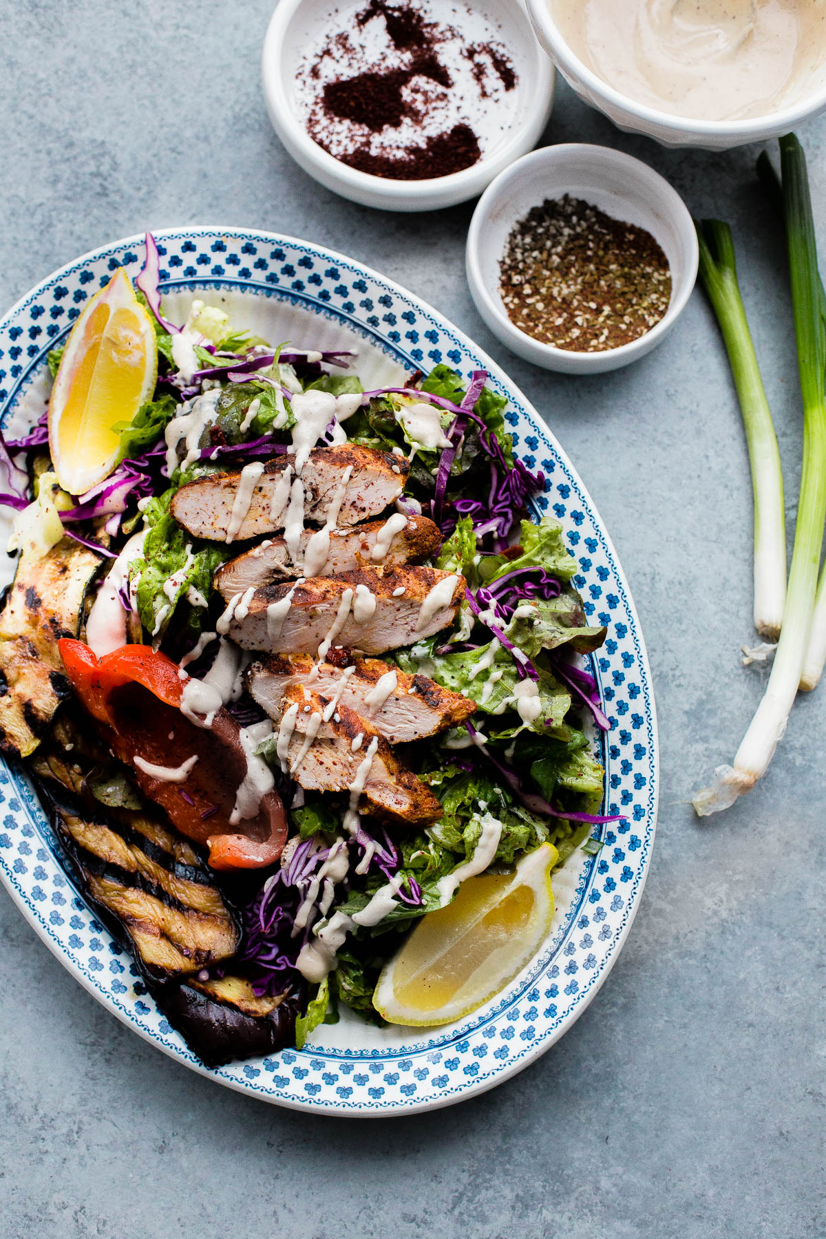 AMAZING Mediterranean Chicken Salad with Sumac Dressing. This salad is packed with flavor and is topped with tahini dressing! 