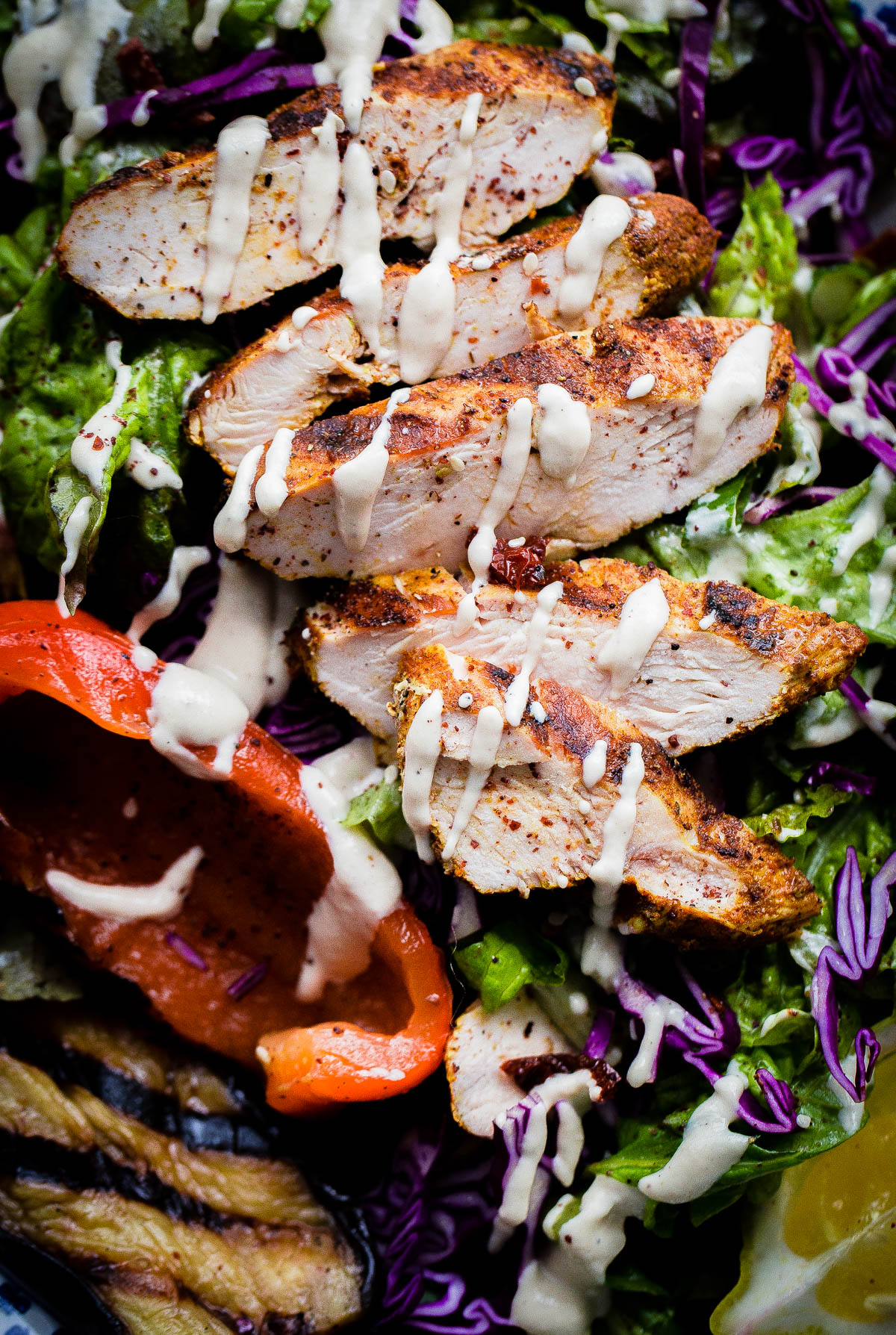 AMAZING Mediterranean Chicken Salad with Sumac Dressing. This salad is packed with flavor and is topped with tahini dressing! 