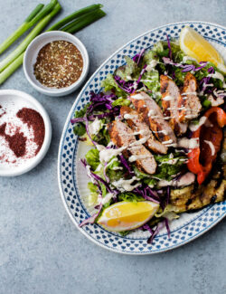 AMAZING Mediterranean Chicken Salad with Sumac Dressing. This salad is packed with flavor and is topped with tahini dressing!