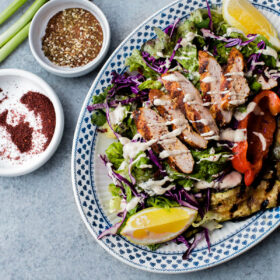 AMAZING Mediterranean Chicken Salad with Sumac Dressing. This salad is packed with flavor and is topped with tahini dressing!