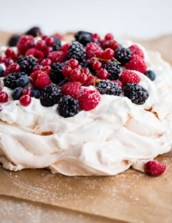 Delicious and Easy Lemon Berry Pavlova Recipe - this delicious pavlova is filled with lemon whipped cream and fresh berries!