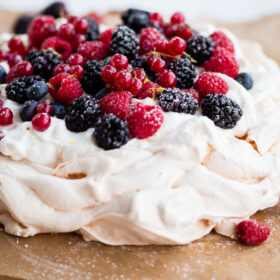 Delicious and Easy Lemon Berry Pavlova Recipe - this delicious pavlova is filled with lemon whipped cream and fresh berries!