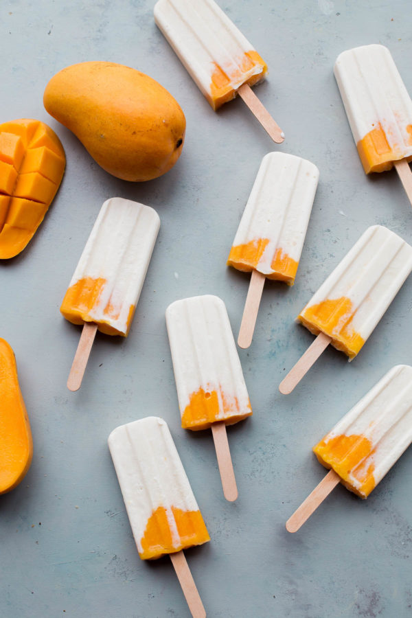 Mango Lassi Popsicles - EASY healthy mango popsicles made with Greek yogurt and naturally sweetened!