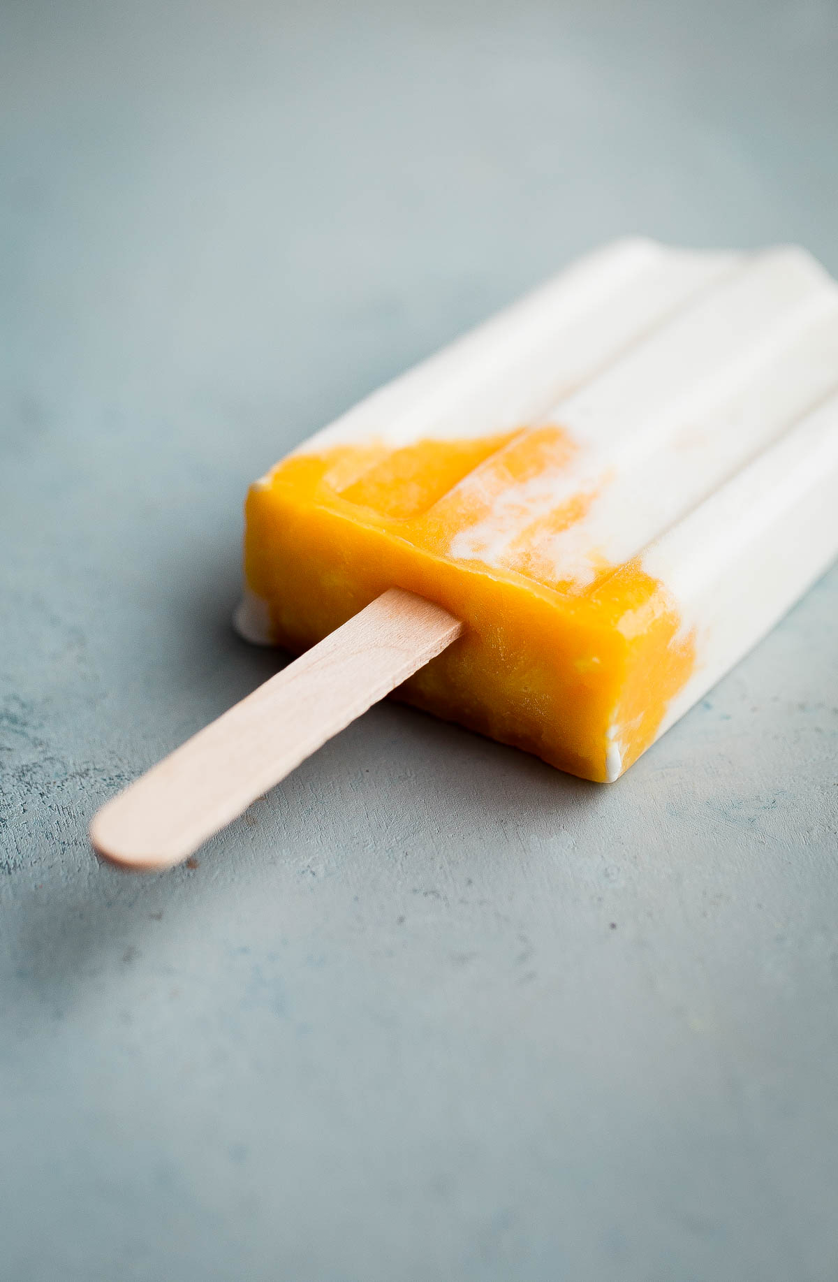 Mango Lassi Popsicles - healthy mango popsicles made with Greek yogurt, coconut milk, and fresh mango! Naturally sweetened. 