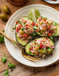 Italian Tuna Avocado Boats - fresh tuna salad made with Bella Portofino extra virgin olive oil packed yellowfin tuna, olives, sundried tomatoes, parsley, and lime served in avocado boats. An easy, healthy, dairy free, gluten free, and paleo friendly recipe!