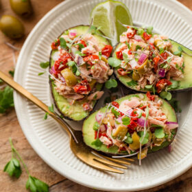 Italian Tuna Avocado Boats - fresh tuna salad made with Bella Portofino extra virgin olive oil packed yellowfin tuna, olives, sundried tomatoes, parsley, and lime served in avocado boats. An easy, healthy, dairy free, gluten free, and paleo friendly recipe!