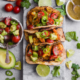 Mumbai Shrimp Tacos with Avocado Salsa - this EASY shrimp taco recipe is packed with spice and topped with a simple avocado tomato salsa!