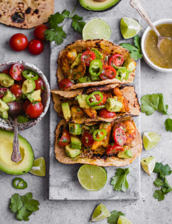 Mumbai Shrimp Tacos with Avocado Salsa - this EASY shrimp taco recipe is packed with spice and topped with a simple avocado tomato salsa!