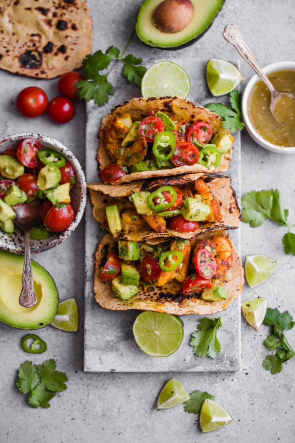 Mumbai Shrimp Tacos with Avocado Salsa - this EASY shrimp taco recipe is packed with spice and topped with a simple avocado tomato salsa!