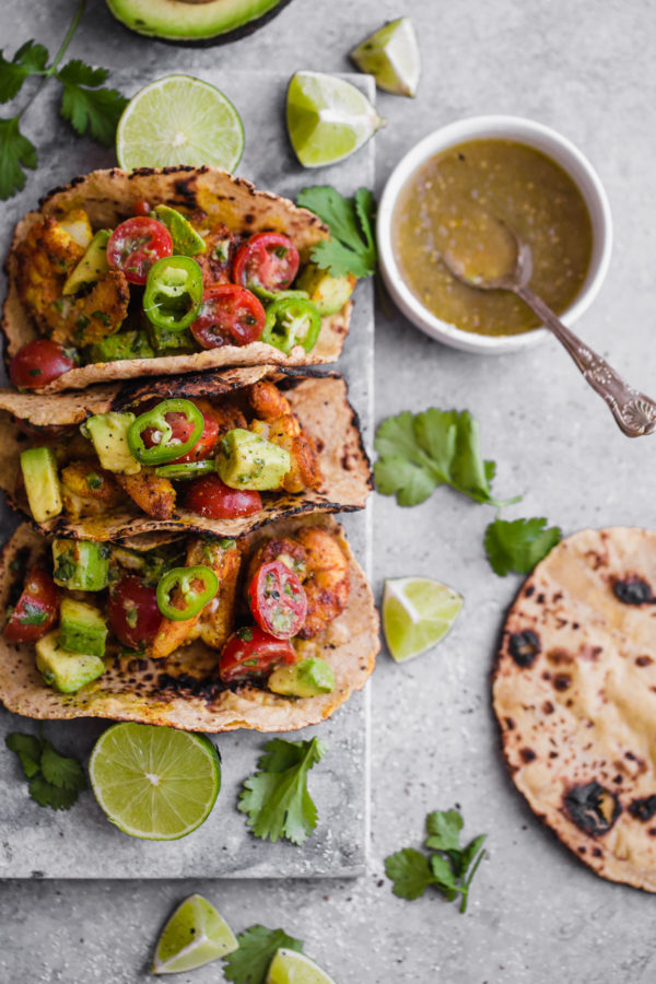 Mumbai Shrimp Tacos with Avocado Salsa - this EASY shrimp taco recipe is packed with spice and topped with a simple avocado tomato salsa!