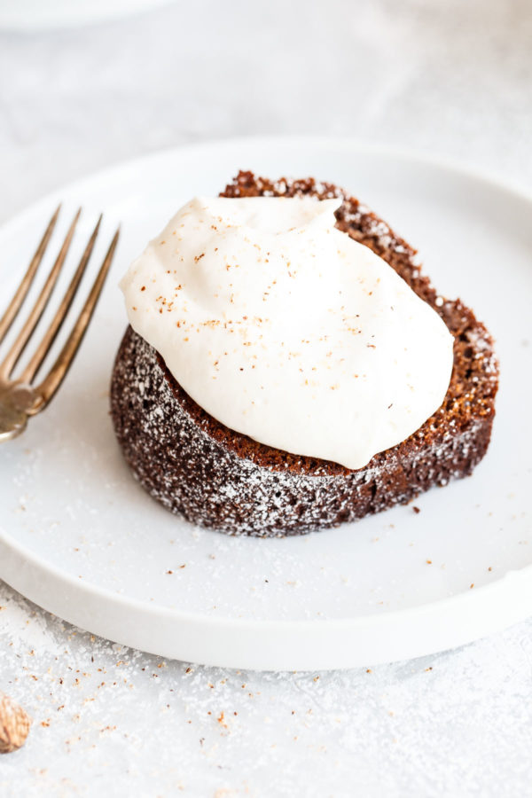 Gingerbread Bundt Cake - this easy, perfectly spiced bundt cake is served with an eggnog whipped cream. A festive cake recipe for the holiday season!