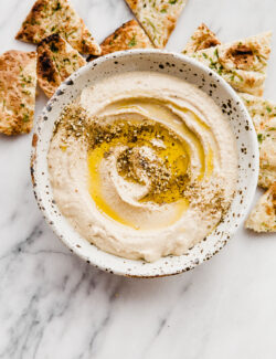 How to Make Hummus - an easy hummus recipe made with canned chickpeas, plus my favorite roasted garlic hummus recipe.