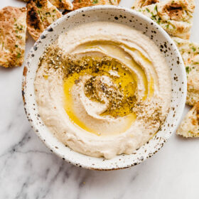 How to Make Hummus - an easy hummus recipe made with canned chickpeas, plus my favorite roasted garlic hummus recipe.