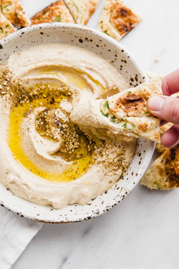 How to Make Hummus - an easy hummus recipe made with canned chickpeas, plus my favorite roasted garlic hummus recipe.