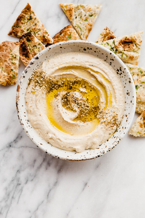 How to Make Hummus - an easy hummus recipe made with canned chickpeas, plus my favorite roasted garlic hummus recipe.