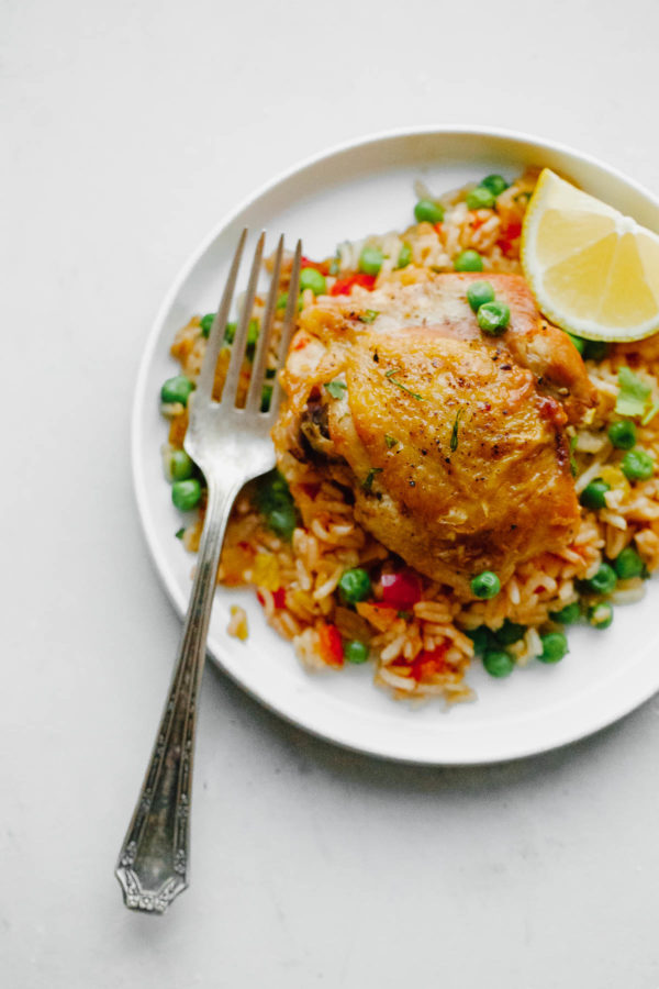 Arroz Con Pollo - an easy, comforting ONE pot meal that comes together in less than 45 minutes. This classic Spanish and Mexican dish is made with rice, chicken, bell peppers, and spices.