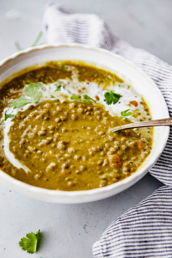 Slow Cooker Curried Lentil Soup - an EASY flavorful lentil soup flavored with turmeric, ginger, cardamom, cloves, cinnamon, and coconut milk.