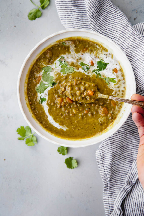 Slow Cooker Curried Lentil Soup - an EASY flavorful lentil soup flavored with turmeric, ginger, cardamom, cloves, cinnamon, and coconut milk.