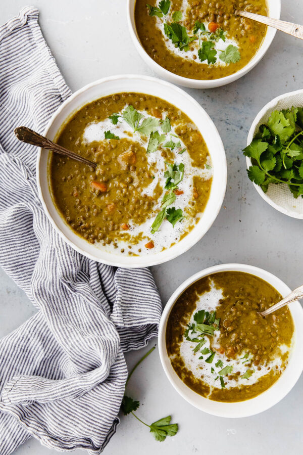 Slow Cooker Curried Lentil Soup - an EASY flavorful lentil soup flavored with turmeric, ginger, cardamom, cloves, cinnamon, and coconut milk.