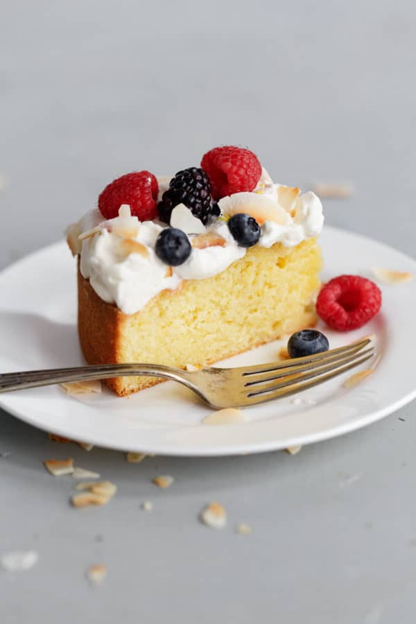 Slice of Lemon Coconut Cake with Cream and Berries