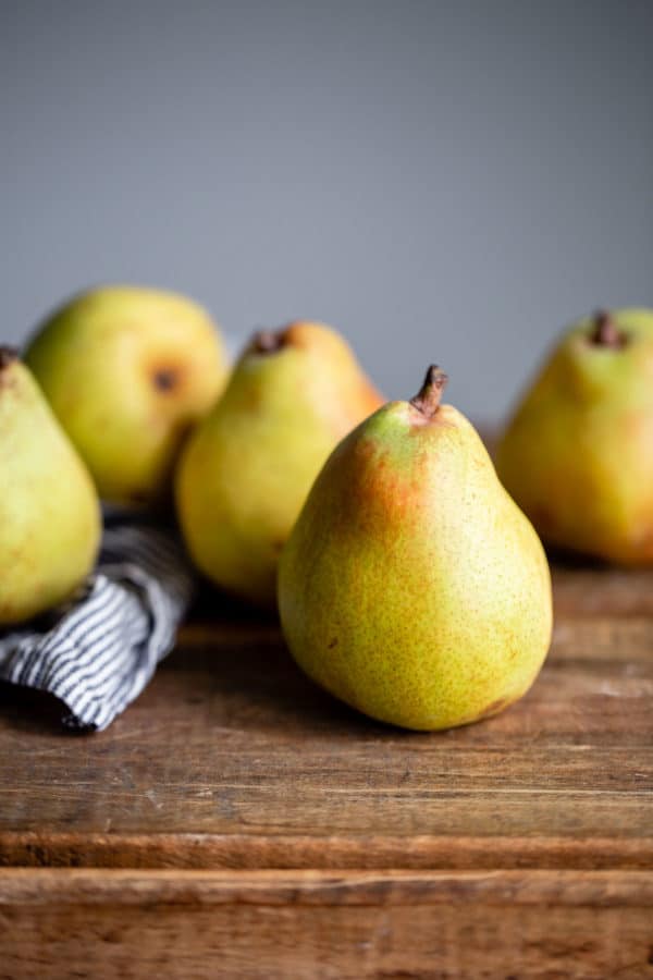 Pear Frangipane Tart - this classic French poached pear tart recipe is made with a sweet tart dough and filled with poached pears and frangipane (almond cream). This tart is delicious and is wonderful served on Thanksgiving or over the holiday season! Top with powdered sugar or apricot glaze. #tart #recipe #abeautifulplate #pear #frangipane #poached #French #dessert #pastry