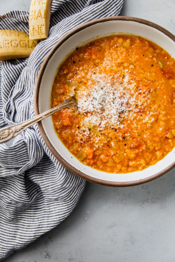 Red Lentil Soup in Bowl with Grated Parmigiano Reggiano Cheese