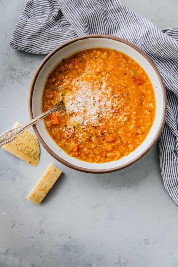 Red Lentil Soup in Bowl with Grated Parmesan Cheese