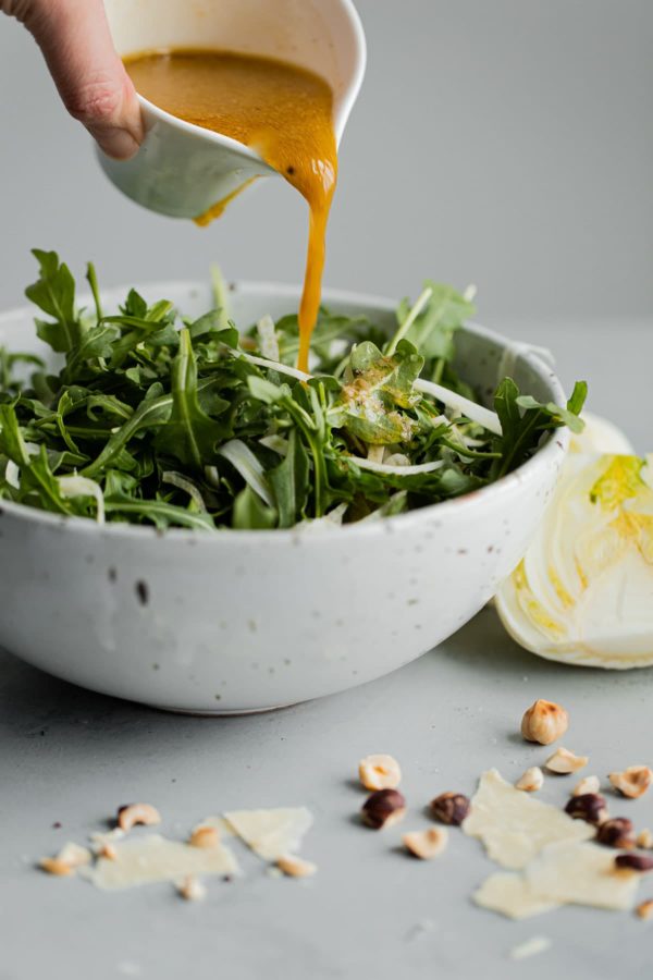 Sherry Vinaigrette Being Poured on Salad