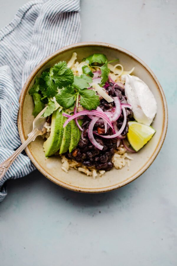 Pressure Cooker Black Beans in Bowl with Avocado and Toppings