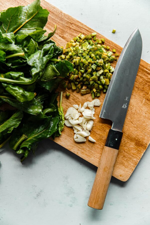 Chopped Beet Greens with Garlic on Cutting Board