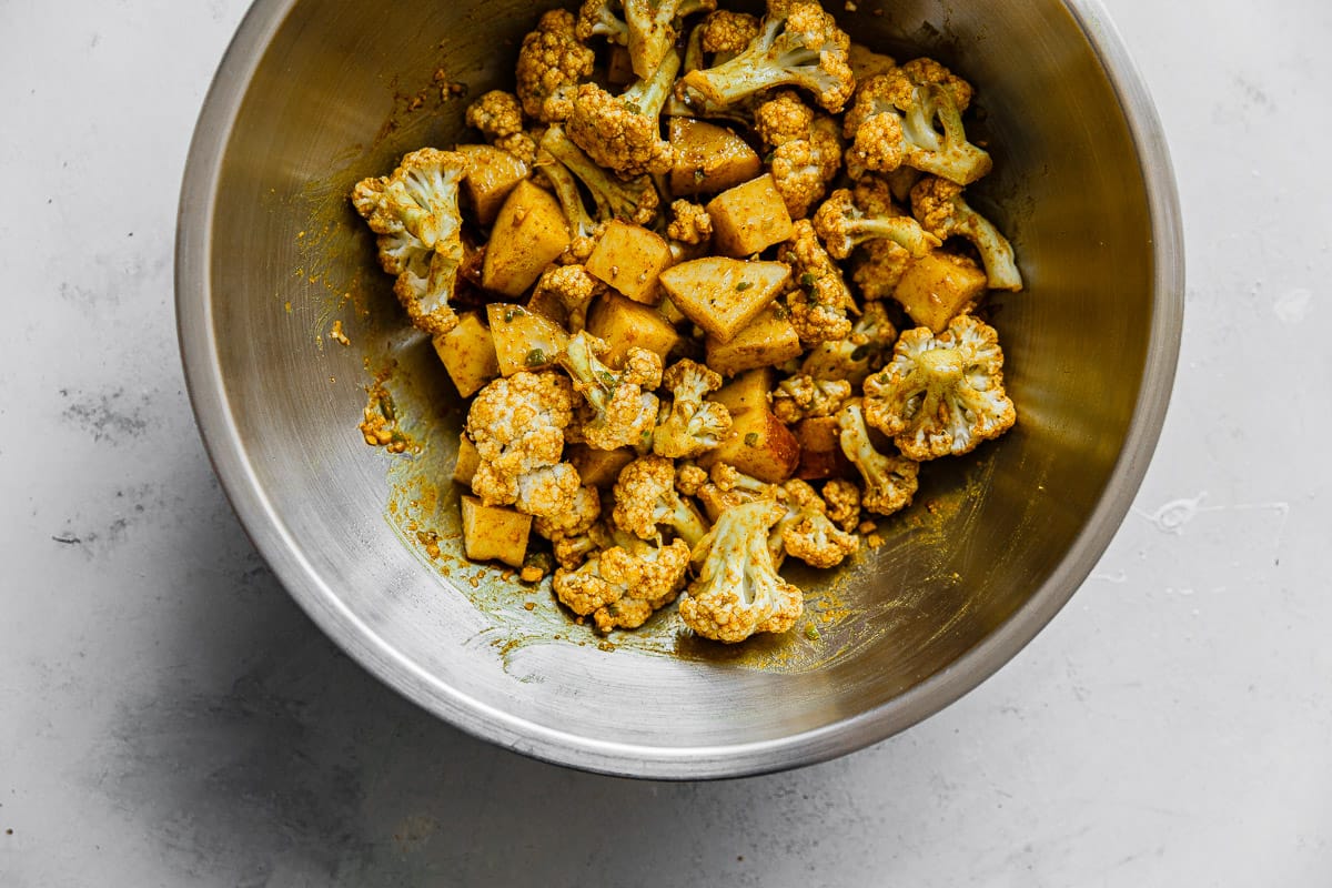 Cauliflower Florets and Curry Spice Mixture in Bowl