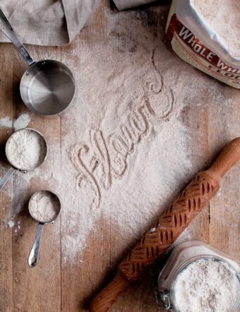 Flour Dusted on Wood Board with Measuring Cups